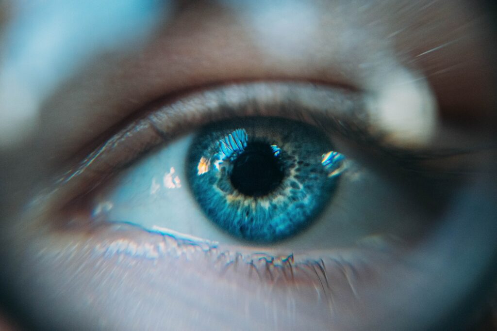 A woman's blue eye up close representing to the awakening when you quit taking it personally and look inside for validation
