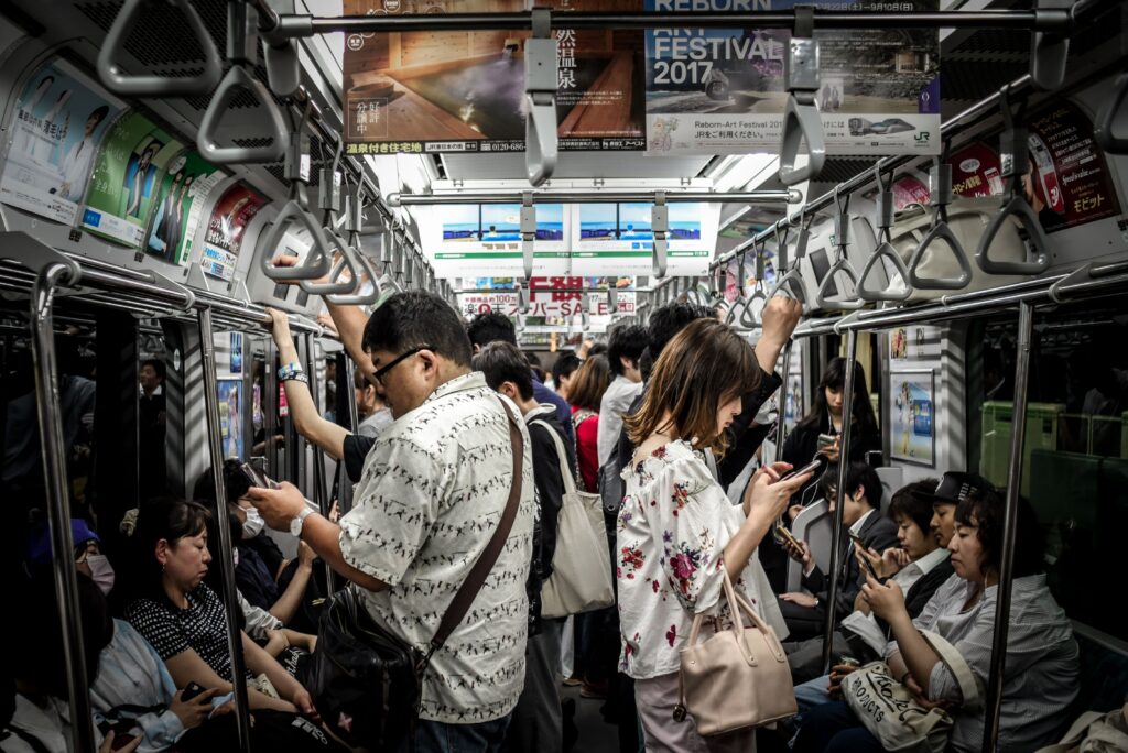 A crowded subway car in which everyone is distracted by their phones completely failing human interaction.