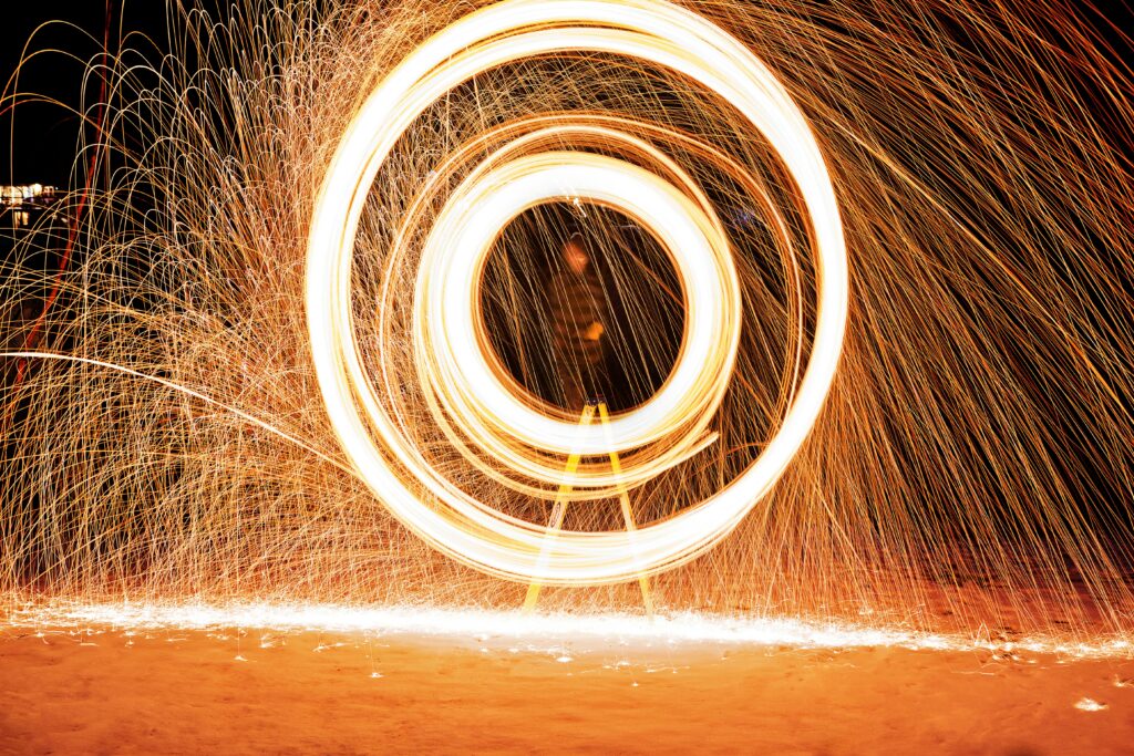 A spinning swirl of sparking lights representing the endless cycle of trying to do more because you feel rested from doing less.