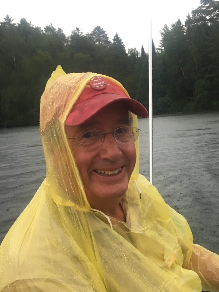 Celebrating Dad: A photo of the author's father in a a yellow rain slicker and red ball cap.