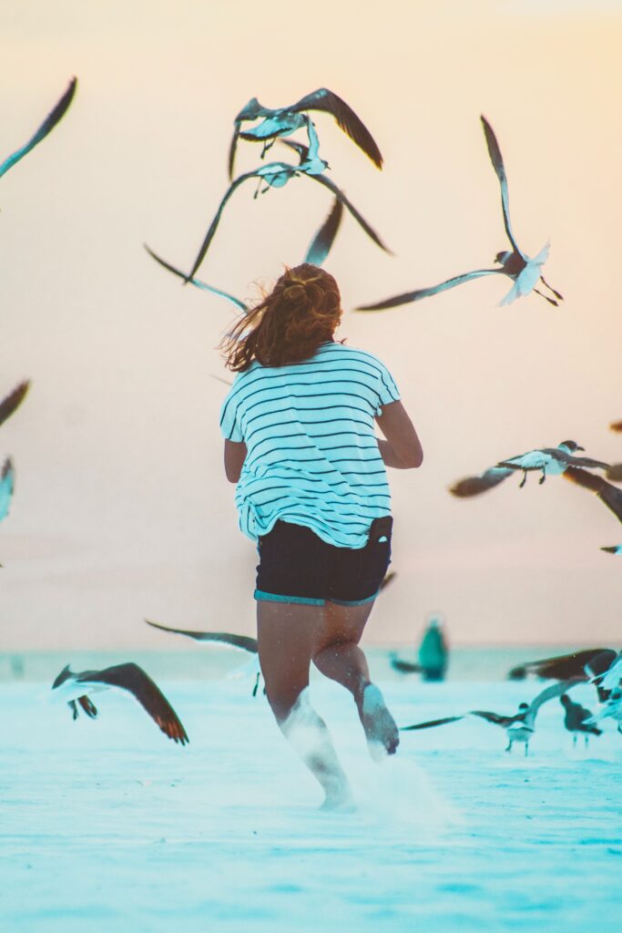 A woman running through the water  chasing seagulls. Such happiness comes when you learn to pace yourself.