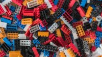 A pile of multicolor legos required to shape a new normal