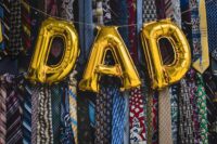 Dad balloon across a wall of neck ties