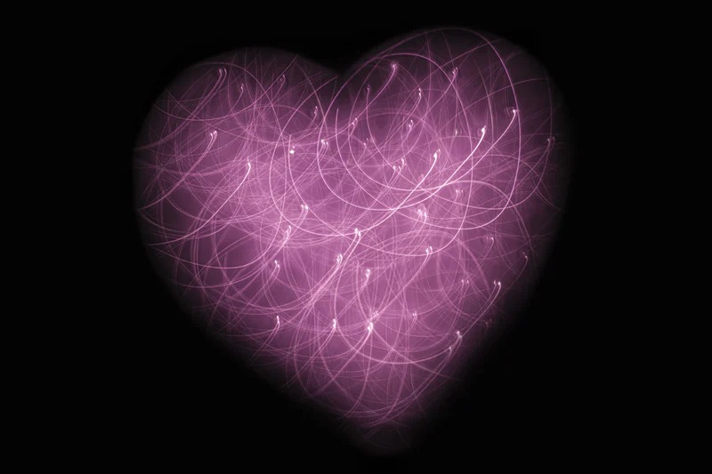 A burgundy heart shaped by strands of beautiful light