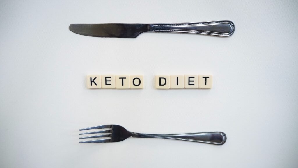 Keto Diet spelled out in scrabble letters with a knife above and a fork below