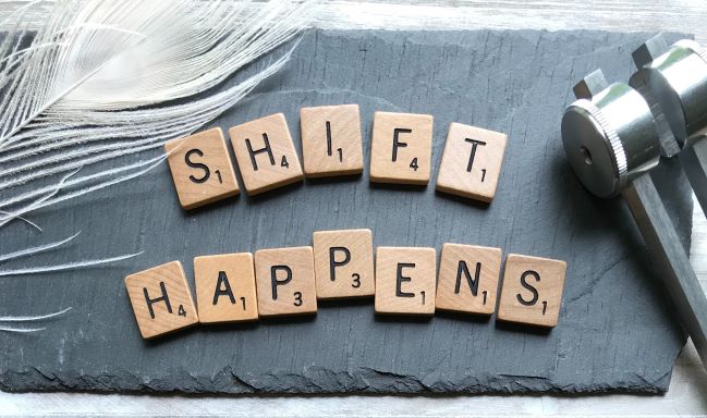 Scrabble tiles that spell out Shift Happens