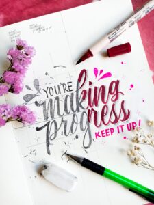 "You're Making Progress: Keep it up! written in calligraphy with fuchsia highlights